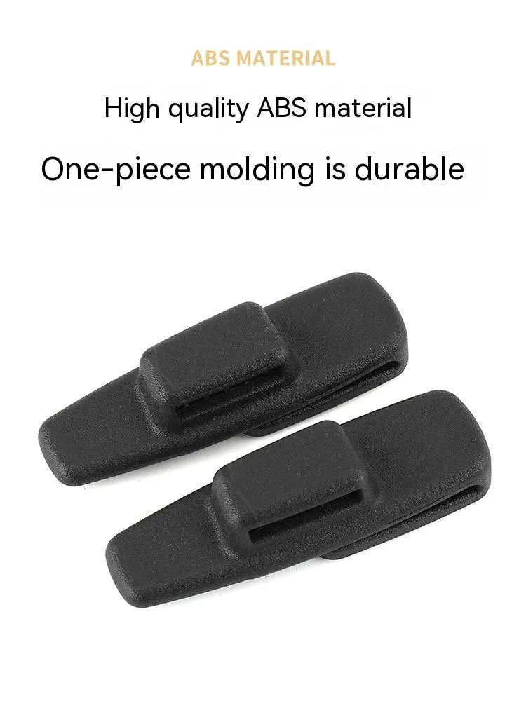 Two black ABS plastic car seat belt stopper clips in clear OPP packaging