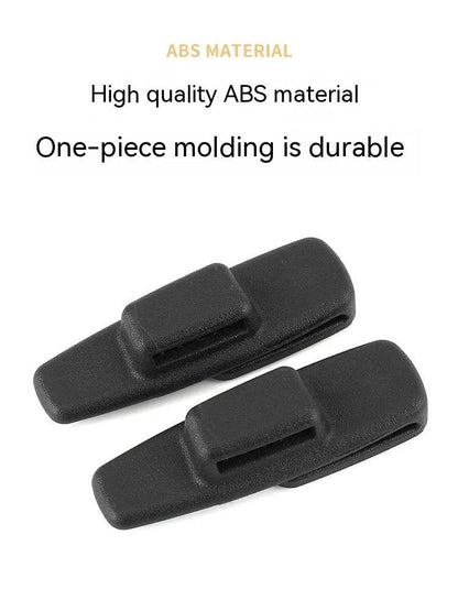 Two black ABS plastic car seat belt stopper clips in clear OPP packaging