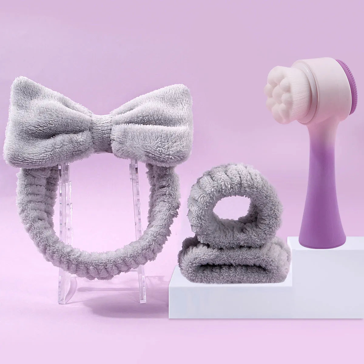 Facial brush set with coral fleece hair band and four nylon-bristle brushes in purple, grey, white, or pink colours