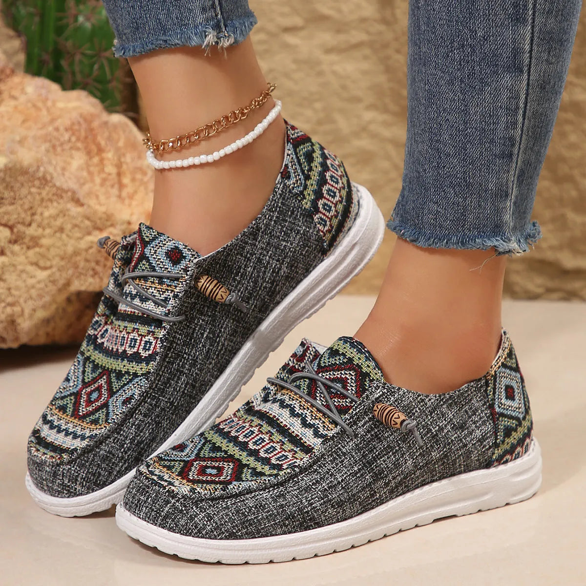 Women's black slip-on flat shoes with round toe and low-top design on a neutral background.
