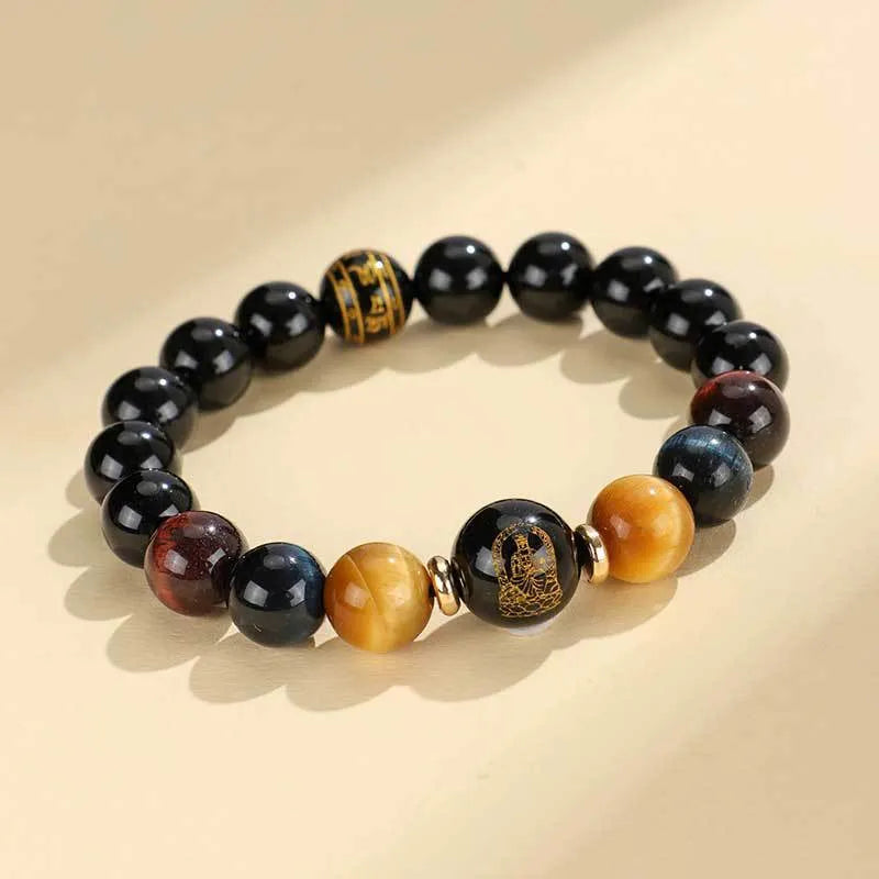 Handcrafted black agate and tiger eye stone beaded bracelet with a central carved zodiac deity charm.