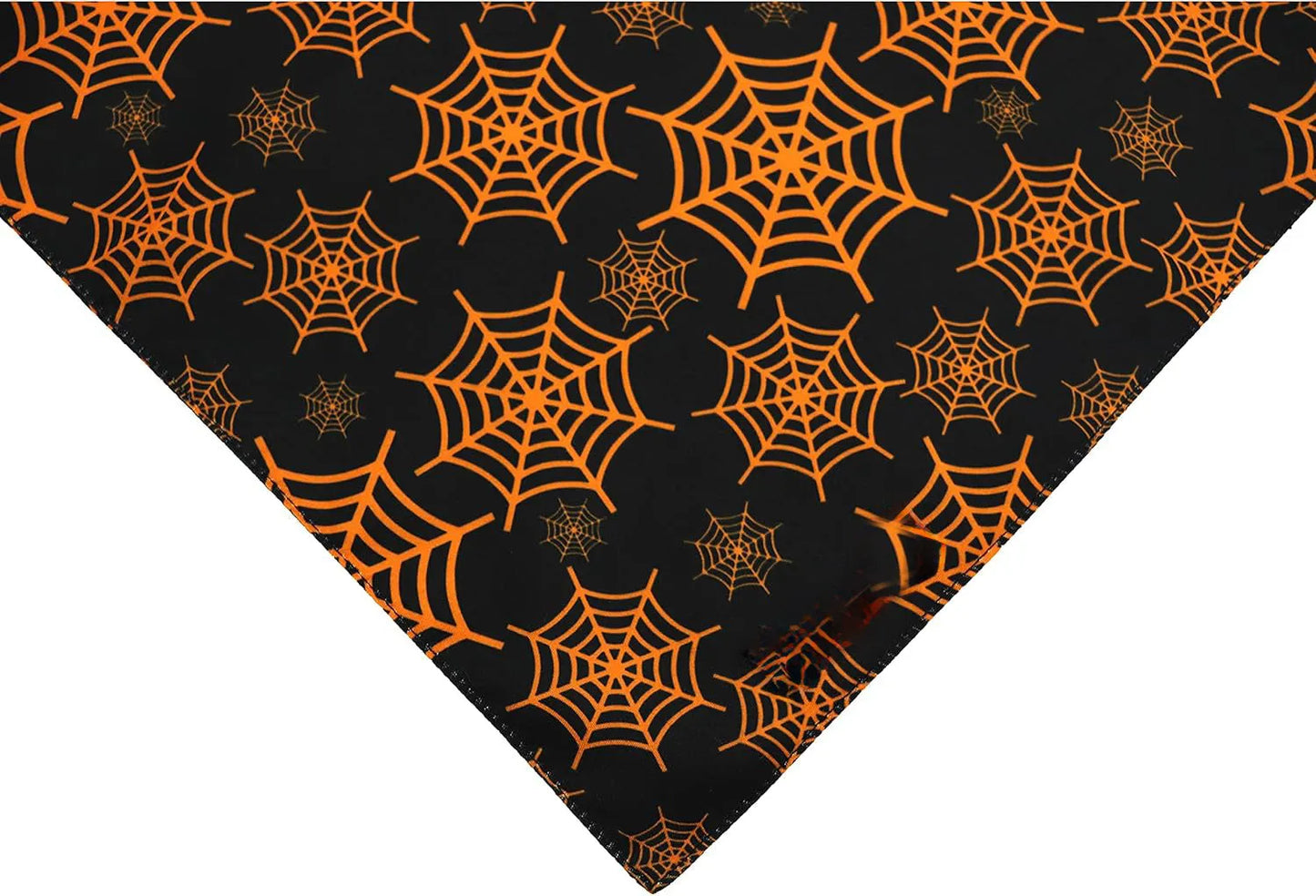 Black and orange reversible Halloween dog bandana with pumpkin and spider web patterns, adjustable for necks up to 16 inches