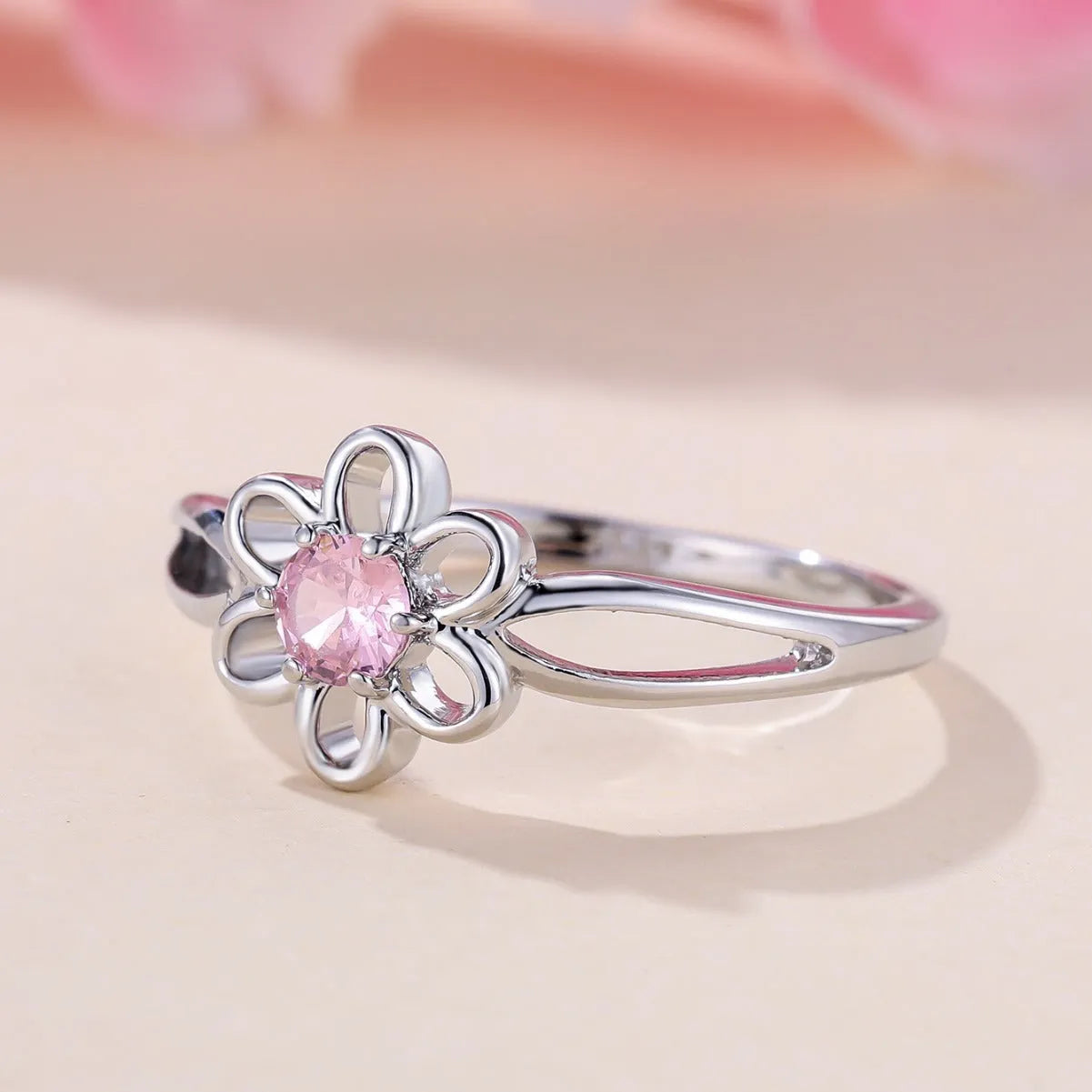 Women's flower hollow ring in pink diamond colour with floral design on copper band