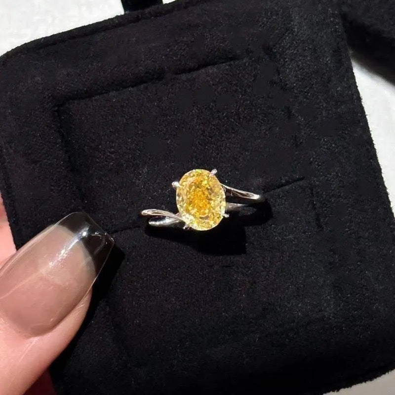 Women's yellow rock sugar crystal copper fashion ring on a hand.