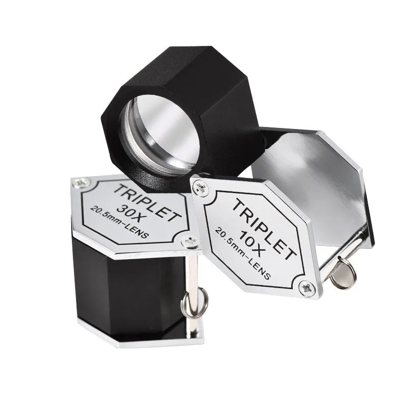 Handheld metal magnifying glass with optical glass lens for jewellery and coin inspection.