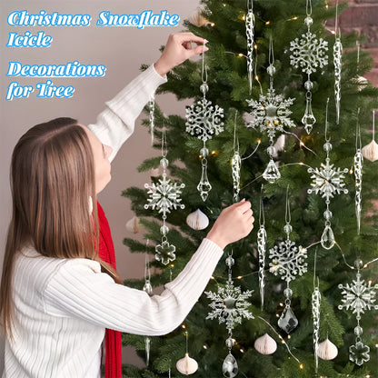 Set of ten clear acrylic icicle-shaped Christmas tree ornaments with white ribbons on green pine branches.