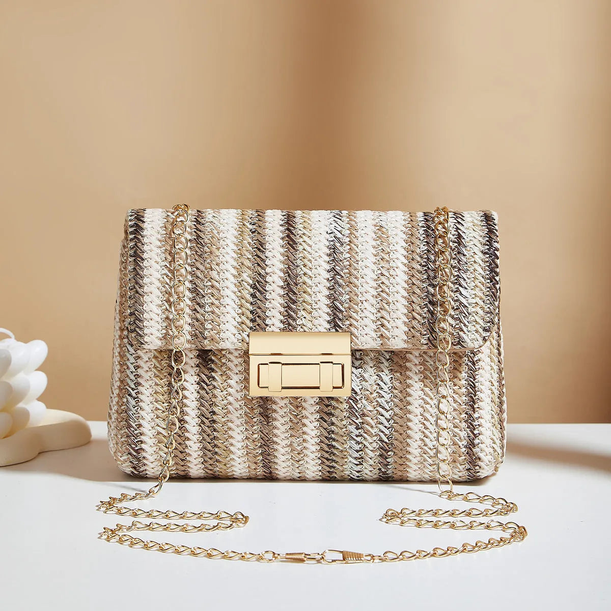 Women's small square straw cross-body bag with lock closure, shown in rainbow colour.