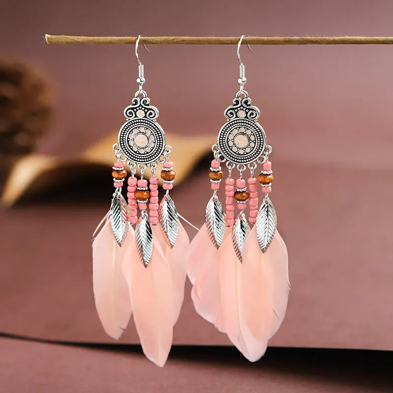 Round drop feather earrings in a bohemian leaf shape with patterned detail, shown in a light pink electroplated colour.