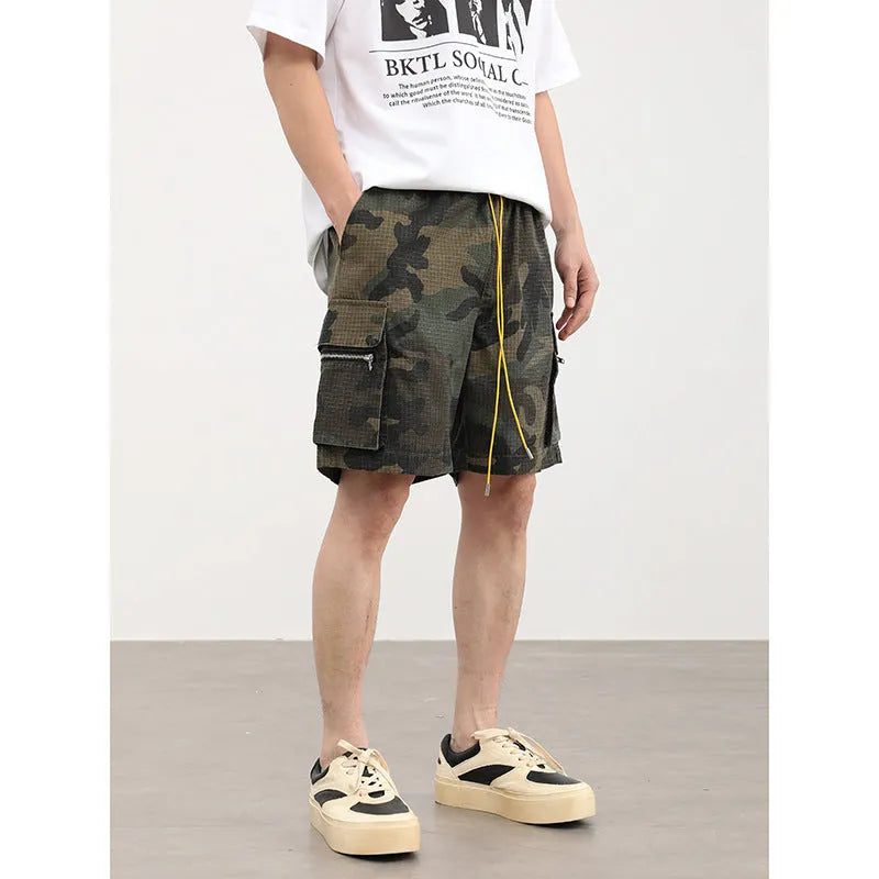 Men's camouflage coloured cargo shorts with multiple pockets and cropped leg length