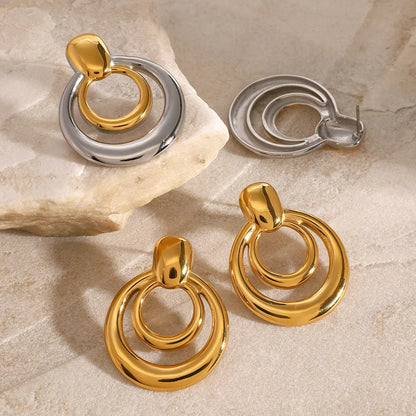 Round double layer hollow stud earrings with 18K gold electroplating on titanium steel, 12mm diameter