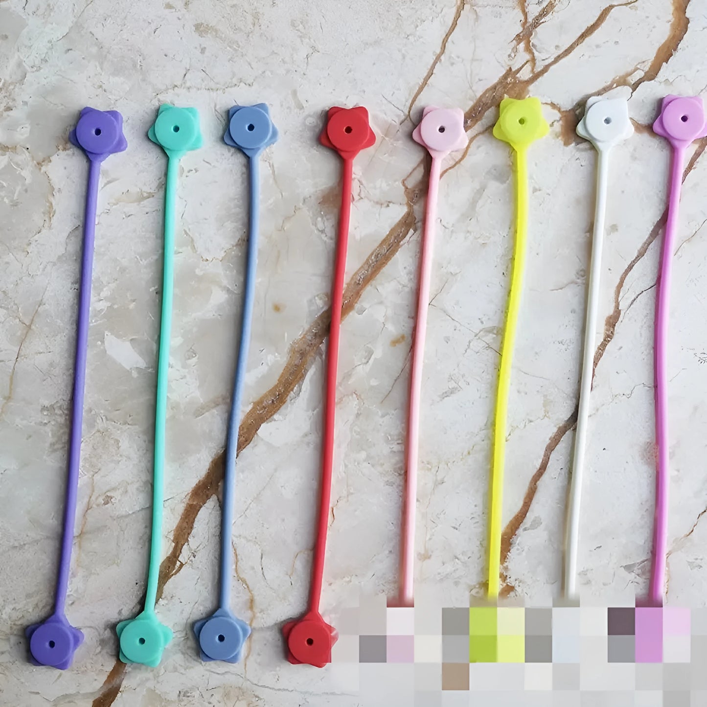 Silicone magnet wire winder for cable organisation in assorted colours on a white background.