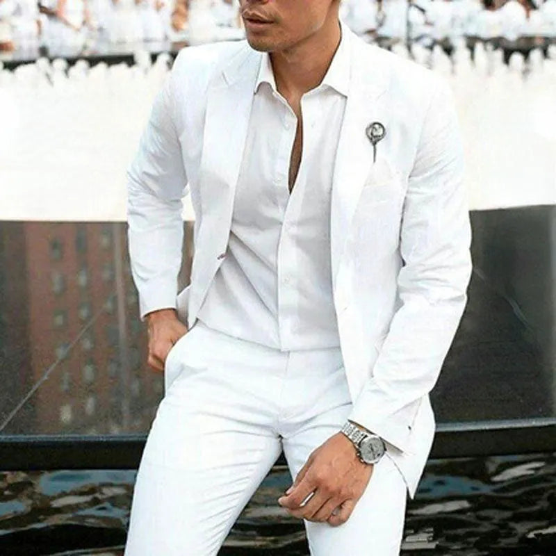 Men's white slim-fit two-piece wedding suit jacket and trousers on a hanger.