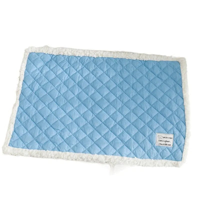 Blue quilted terry cloth pet blanket for cats shown in a cage, with size options M, L, and XL available.