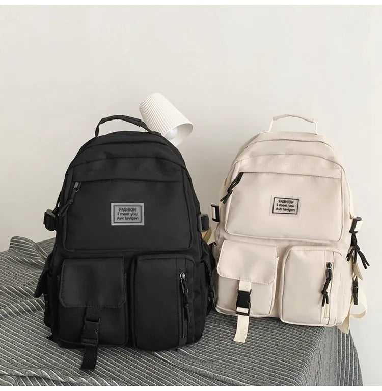 Black and white nylon student backpack with laptop compartment and three-dimensional pocket.