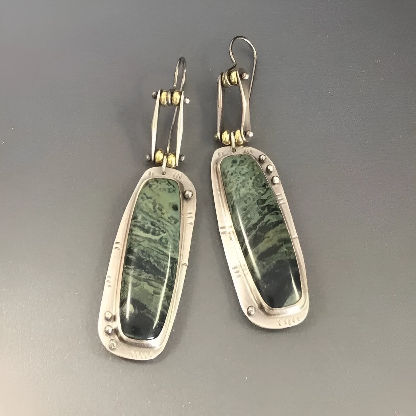 Two-tone geometric marble pattern alloy earrings with butterfly clasp, showing front and side views