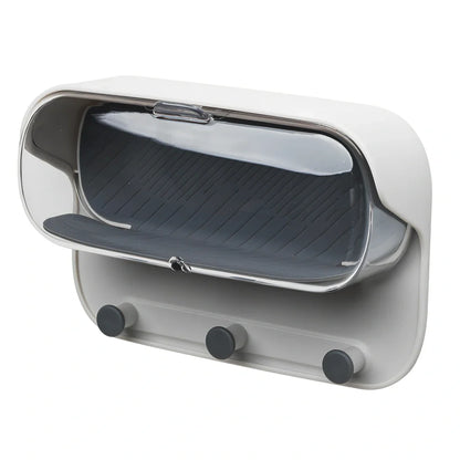 Grey punch-free bathroom storage box mounted on wall with transparent lid showing glasses inside
