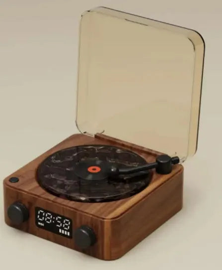 Retro-style turntable Bluetooth speaker with glowing RGB light projection on a wooden surface.