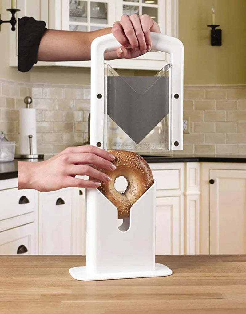 White plastic bagel slicer with clear safety shields and stainless steel blade