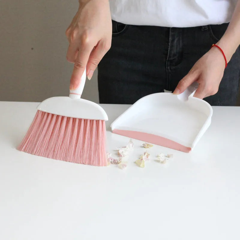 Small plastic handheld dustpan and brush cleaning kit in assorted colours.