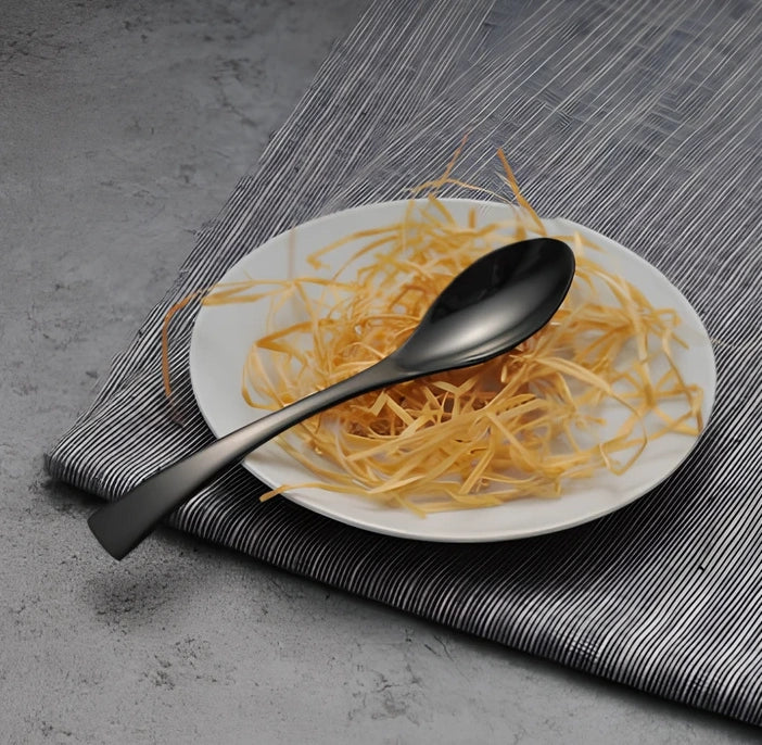 Black stainless steel cutlery set with mirror polish finish showing fork, knife, coffee spoon, soup spoon, steak knife
