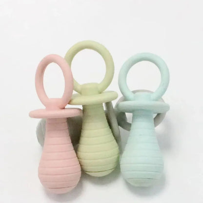 Blue TPR pet pacifier chew toy with squeaker for puppies and kittens on a white background.