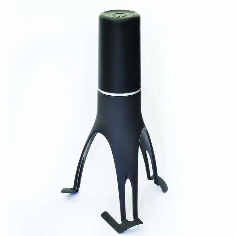 Uutensil Stirr automatic cooking mixer in grey, shown stirring in a pot of sauce.