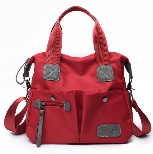 A fashionable and versatile ladies tote bag with multiple compartments and carrying options for the modern woman on the move.