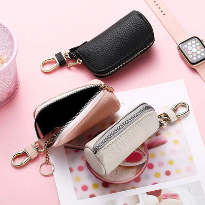 Minimalist black PU leather key wallet with a silver metal zipper closure.