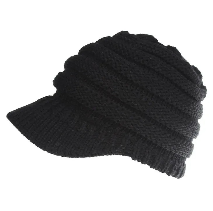 Women's acrylic knitted ponytail beanie in a solid colour, shown on a model with a ponytail.