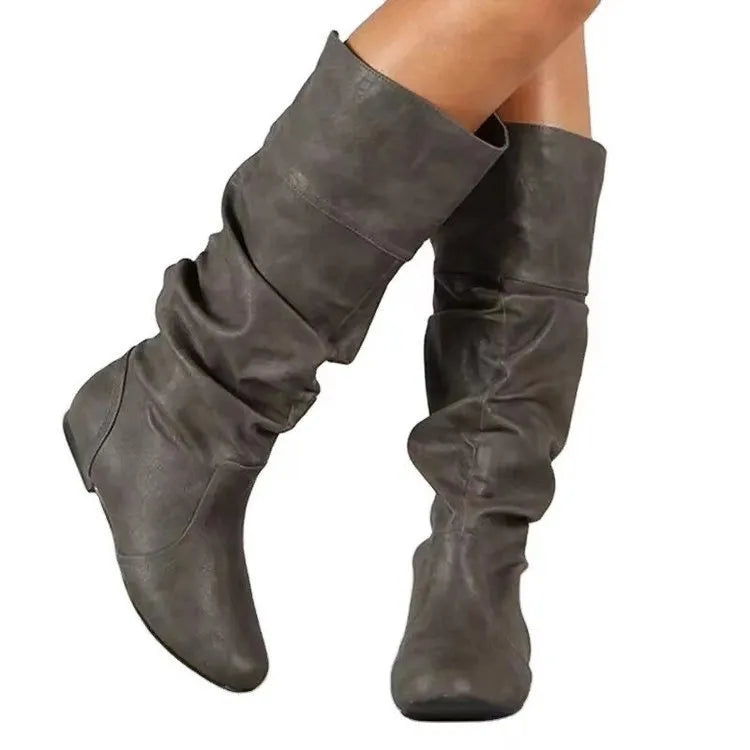 Women's flat heel long boots in black, slip-on style with a high cylinder shaft and rubber sole.