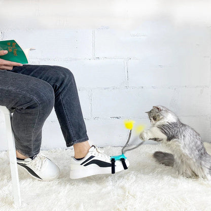 Playful cat chasing and pouncing on a feather-tipped wand toy designed to engage their natural hunting instincts