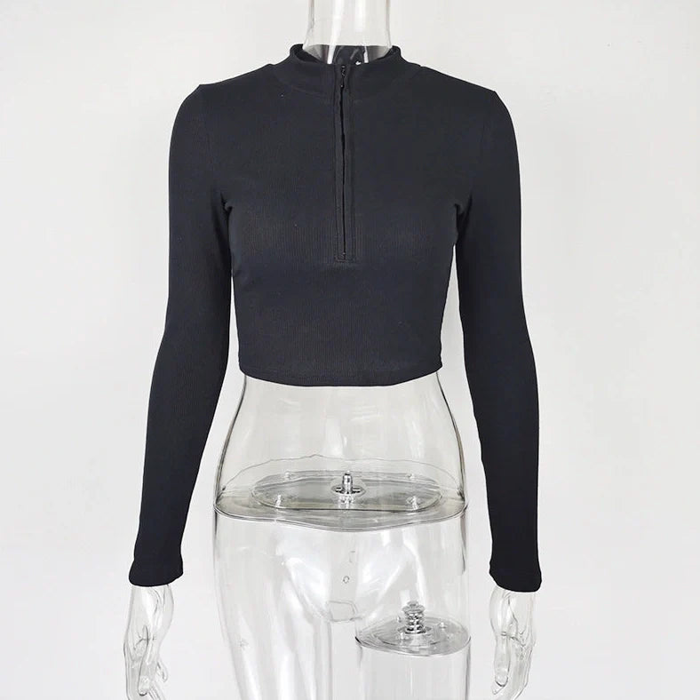 Women's black zip-front crop top with slim fit and long sleeves on hanger
