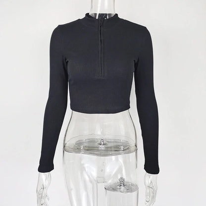 Women's black zip-front crop top with slim fit and long sleeves on hanger