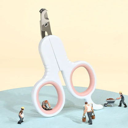 Grey and pink pet nail clippers with curved tips and a rubber-coated ergonomic handle on a table.