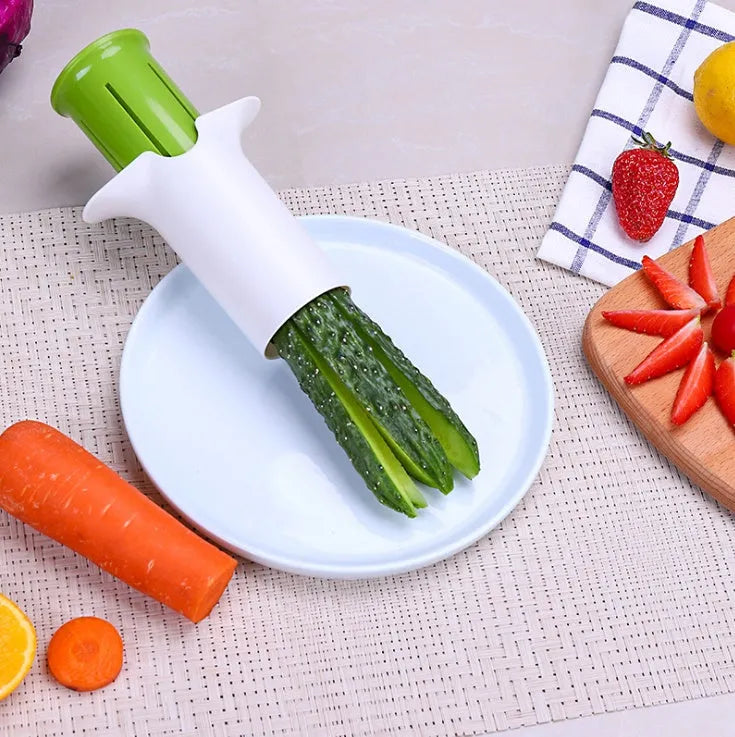 White ABS plastic kitchen slicer with six visible stainless steel blades for cutting cucumbers, carrots, and strawberries.
