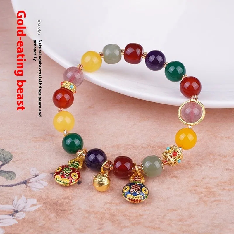 Hand-woven agate bracelet with 10mm beads and a detailed swallowing gold beast charm.