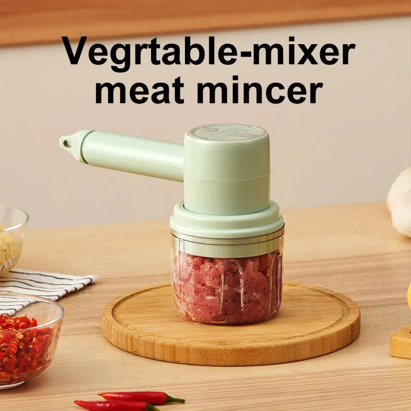 Green rechargeable electric hand mixer with whisk and beater attachments on a kitchen counter