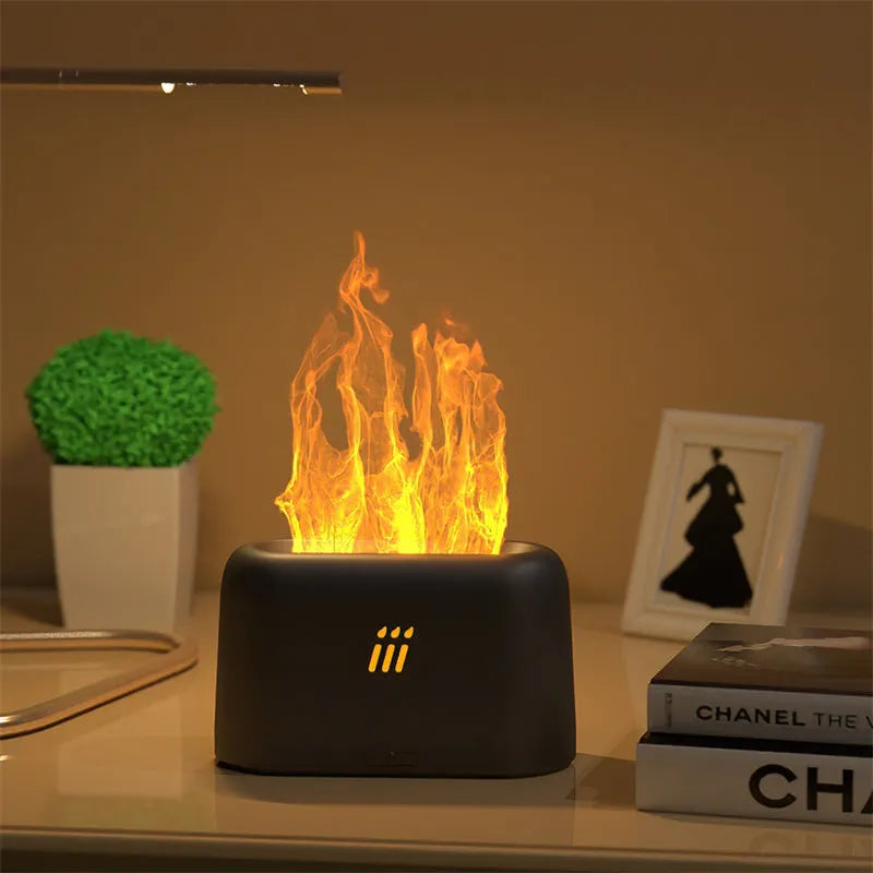 Black ultrasonic flame aroma diffuser humidifier with LED lights on a wooden table