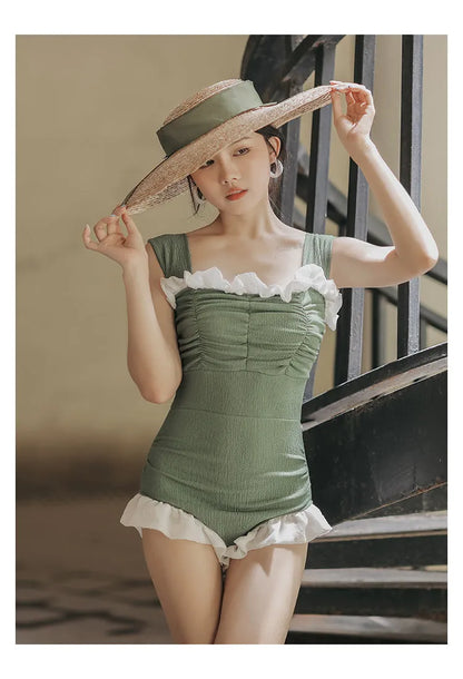 Women's black high-waisted one-piece swimsuit made from quick-drying polyester fabric.