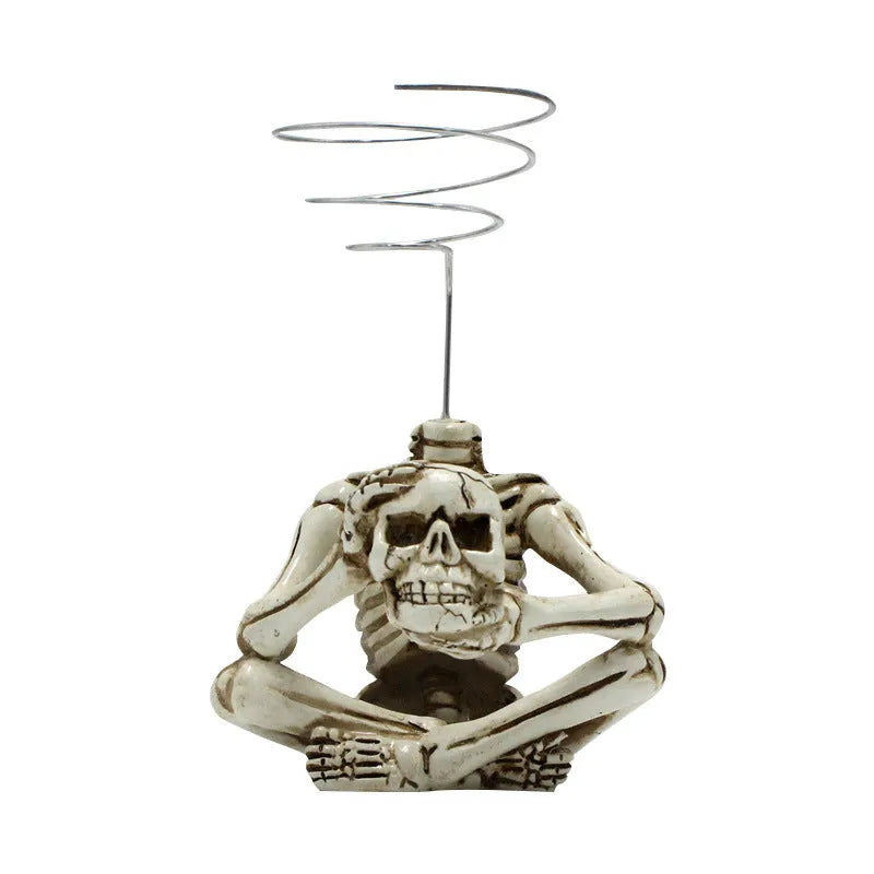 Gothic-style soilless resin bracket with skull motif for air plants, shown with integrated iron stand.