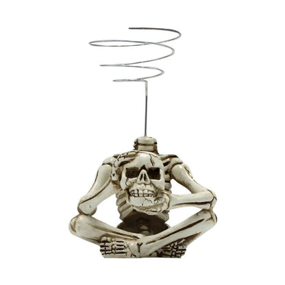 Gothic-style soilless resin bracket with skull motif for air plants, shown with integrated iron stand.
