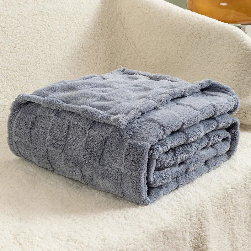 Geometric pattern polyester blanket in dark grey colour draped over sofa
