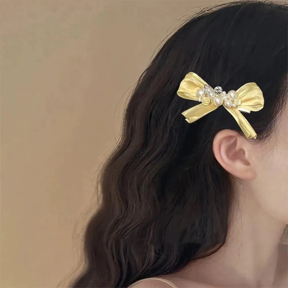 Yellow bow barrette hair clip with rhinestone pearls and duckbill clip mechanism