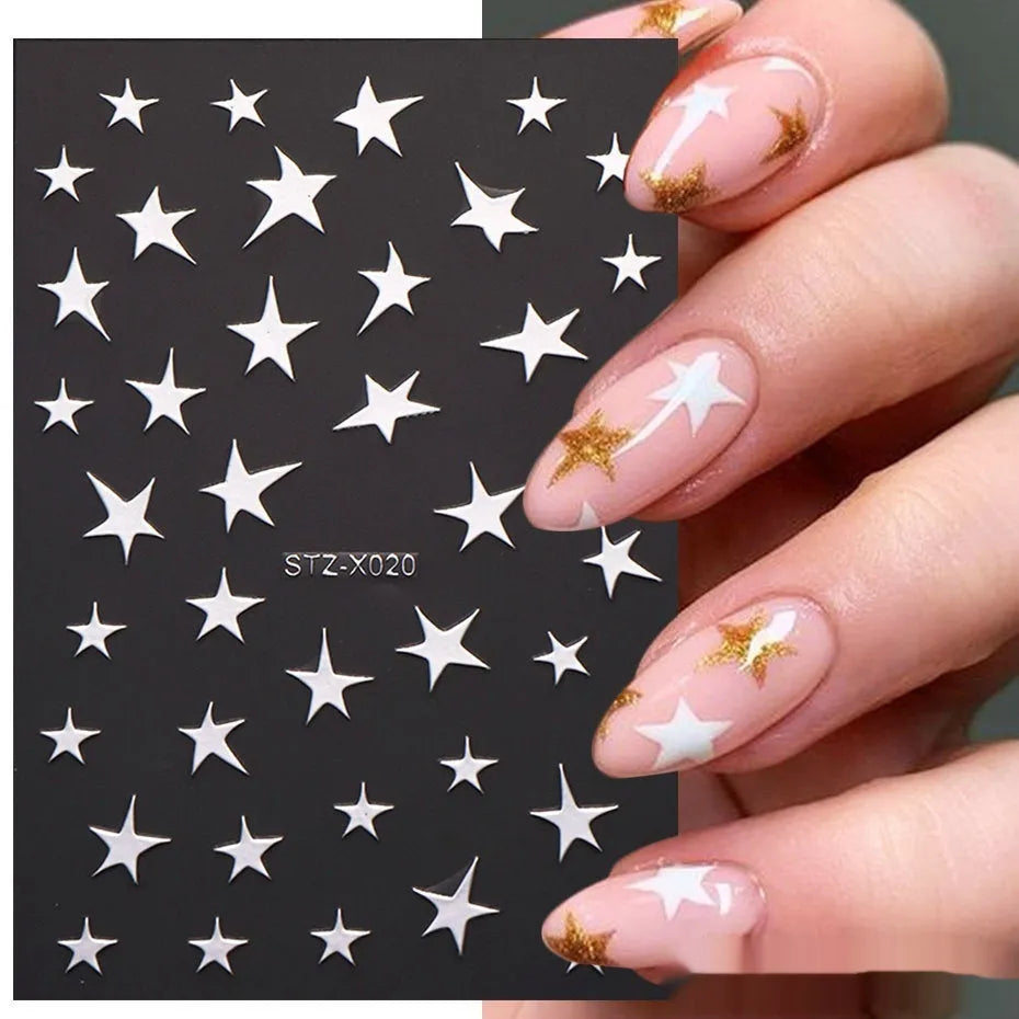Assortment of black and silver nail sticker designs including cartoon and French tip patterns on a plastic sheet.