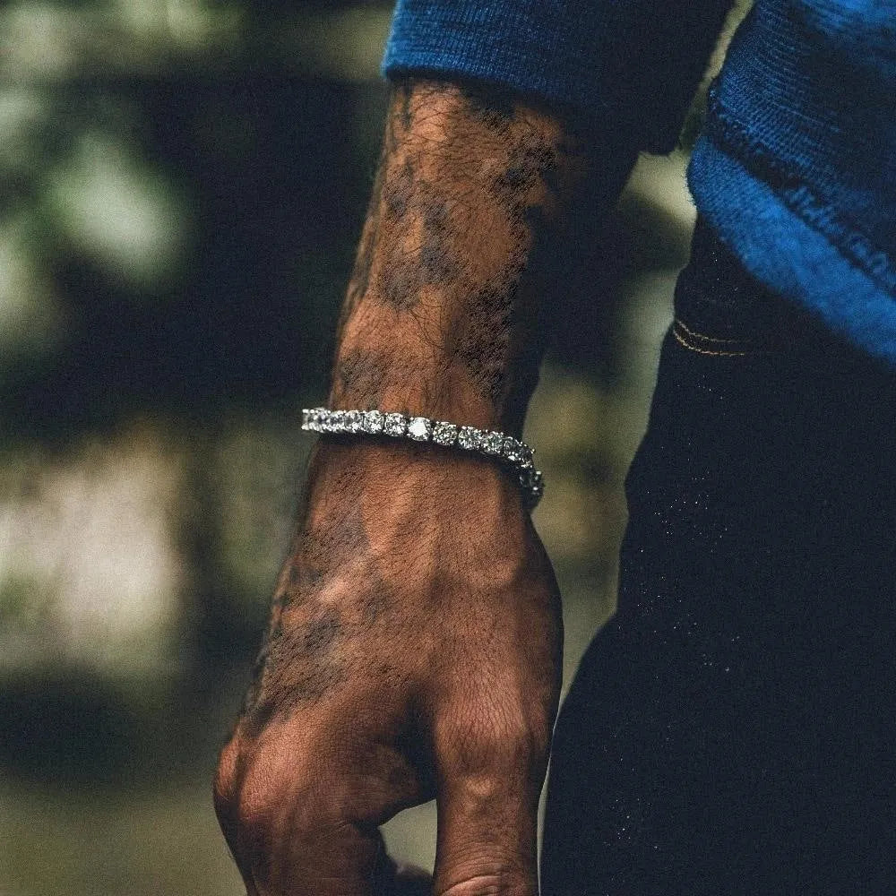 Men's silver alloy link bracelet with a row of clear rhinestones, shown on a wrist.