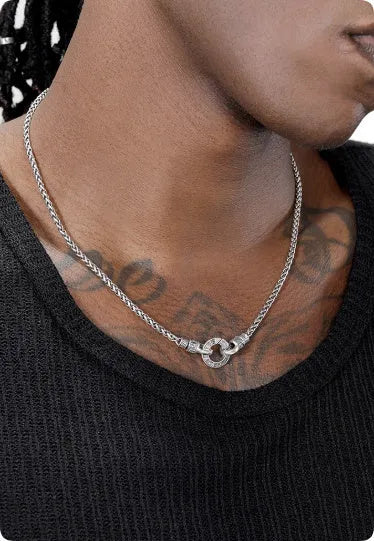 A simple sterling silver clavicle necklace with a small pendant, shown on a model.