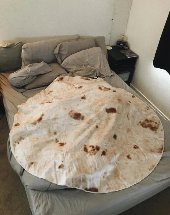 Round flannel burrito blanket with food-themed printing, showing coral fleece texture and wrap-style design