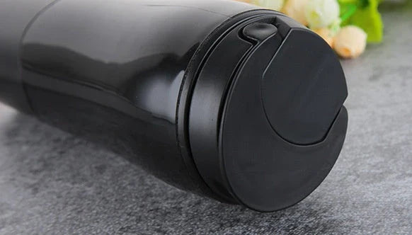 Spill-proof suction cup travel mug with sleek design and carrying strap for convenient on-the-go use