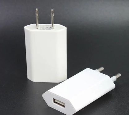 White USB travel charger and Lightning cable for iPhone and iPad on a wooden surface