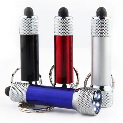 Compact aluminium LED keychain torch in four colours: white, black, red, and blue.